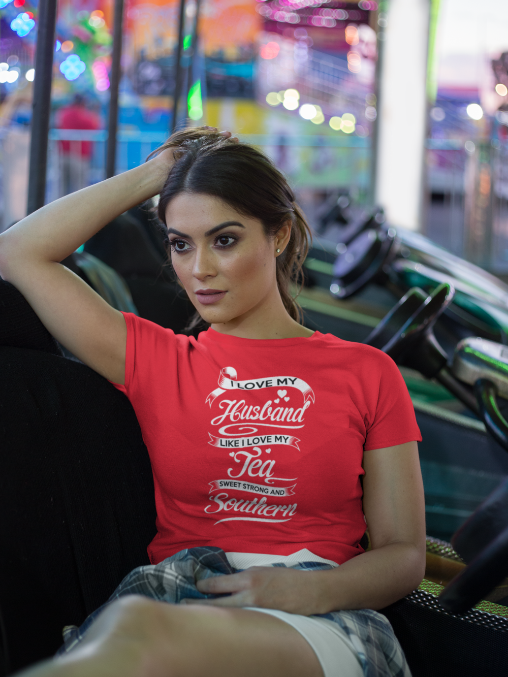 crop top tee mockup being worn by a girl lying on the arcade car games a19440