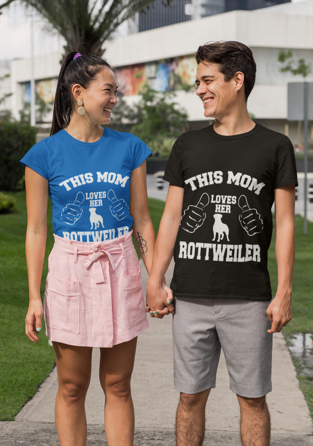 mockup of a young couple with customizable t shirts holding hands 29769