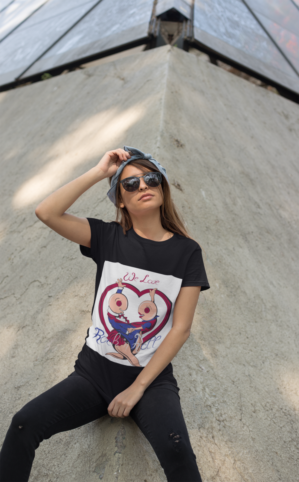 t shirt mockup of a trendy woman with sunglasses leaning over a concrete structure 27340