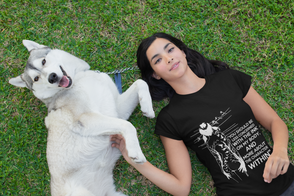 t shirt mockup of a woman lying on the grass with her dog 30660